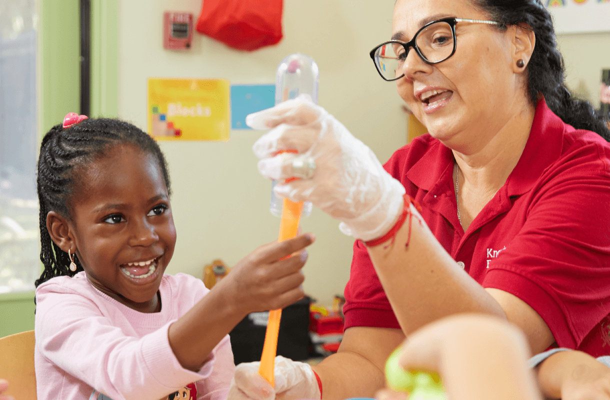 kid playing with teacher