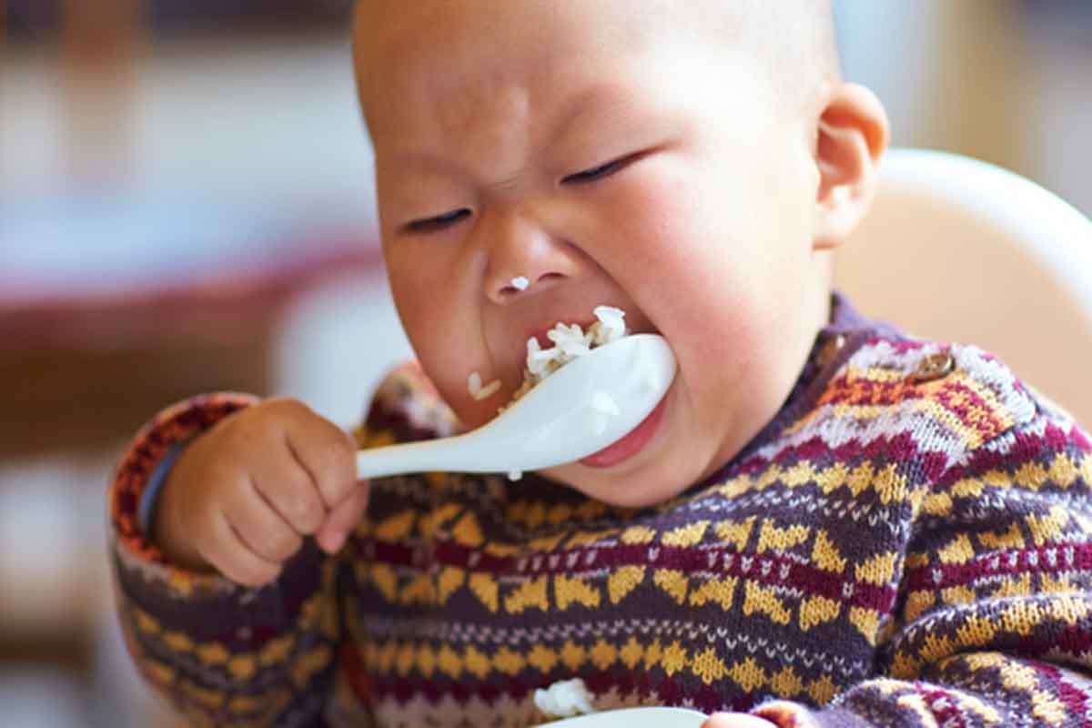 baby eating rice